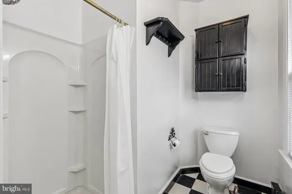 a kitchen with a table chairs and wooden floor