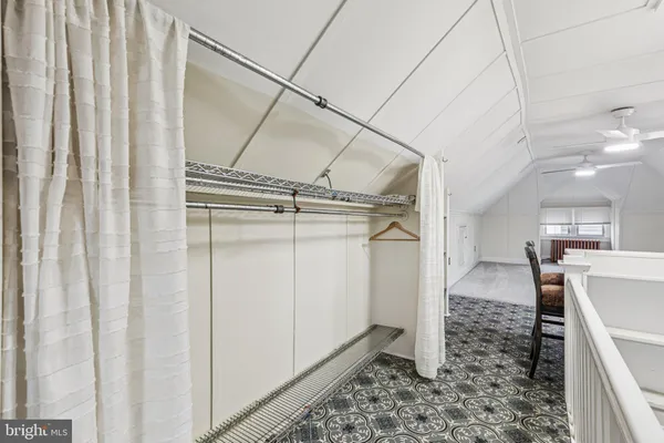 a view of an empty room with a ceiling fan