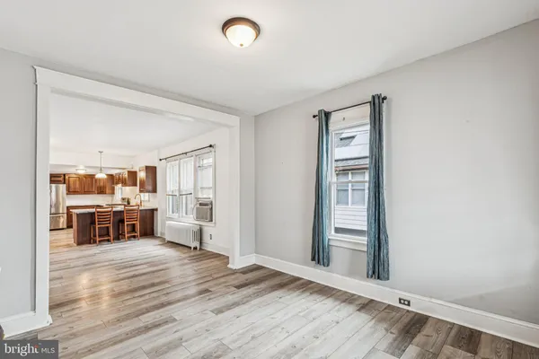 a view of a kitchen with wooden floor and electronic appliances
