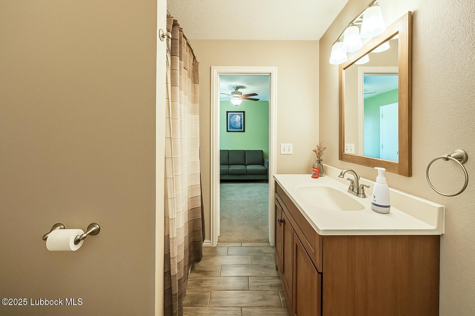 208 South Holliday Plainview, TX 79072 - Photo 12 of 32 a bathroom with a sink and mirror