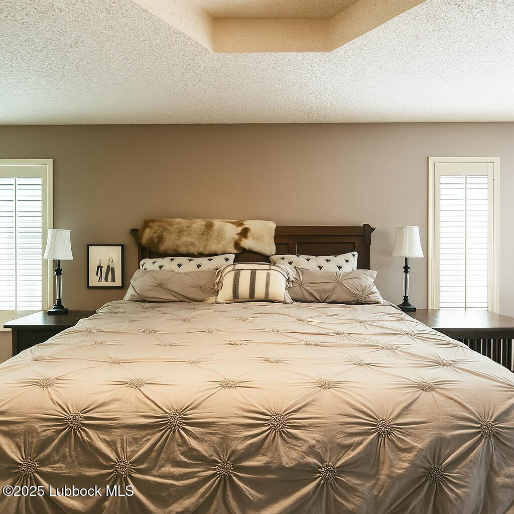 208 South Holliday Plainview, TX 79072 - Photo 15 of 32 a large bed sitting in a bedroom next to a window