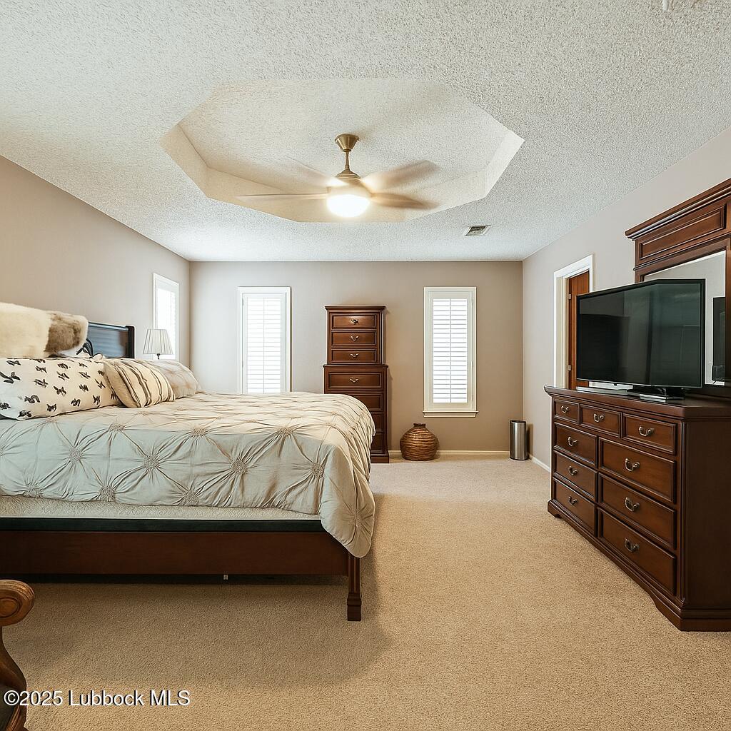 208 South Holliday Plainview, TX 79072 - Photo 16 of 32 a bedroom with a large bed and a flat screen tv