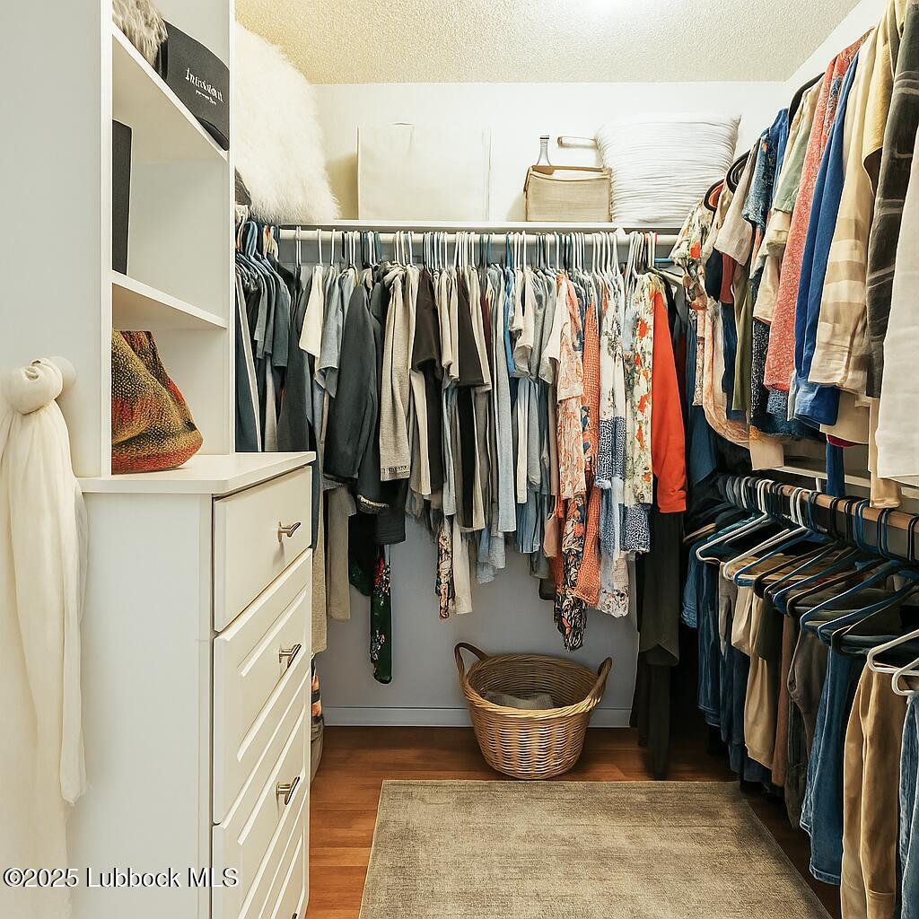 208 South Holliday Plainview, TX 79072 - Photo 17 of 32 a view of walk in closet with clothes and shoes