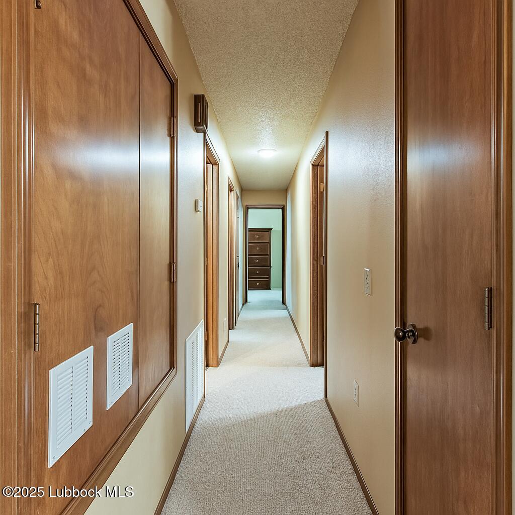 208 South Holliday Plainview, TX 79072 - Photo 23 of 32 a view of a hallway with wooden cabinets