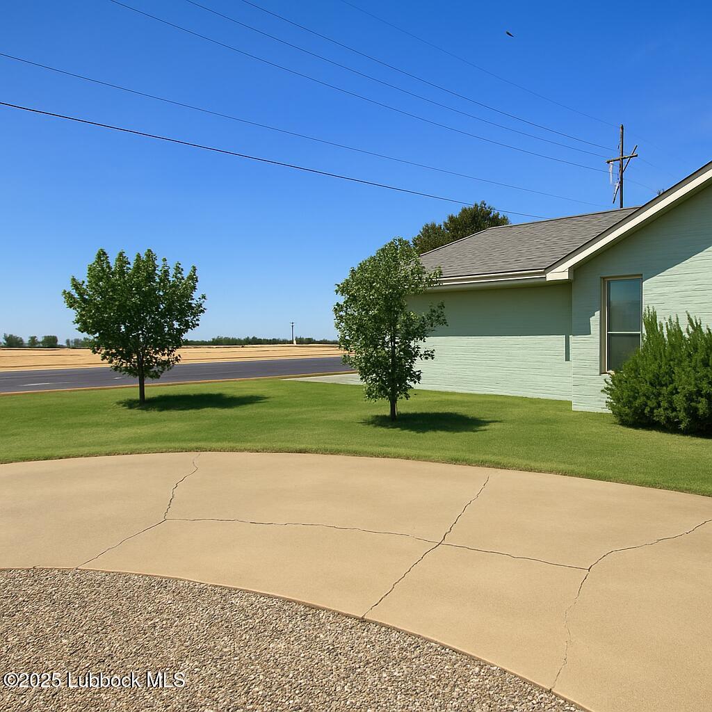 208 South Holliday Plainview, TX 79072 - Photo 3 of 32 a front view of a house with a yard and a garage