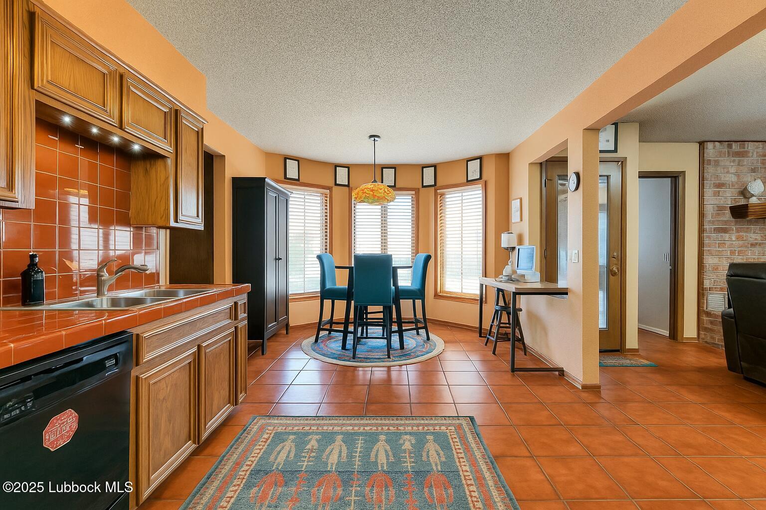 208 South Holliday Plainview, TX 79072 - Photo 9 of 32 a living room with stainless steel appliances granite countertop furniture a fireplace and a view of kitchen