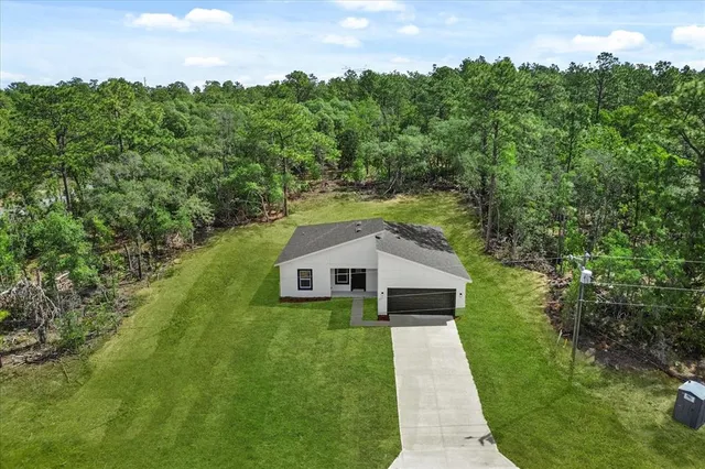 a aerial view of a house with a yard