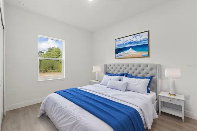 a bedroom with bed and window