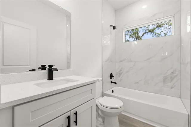 a bathroom with a sink a toilet and bathtub