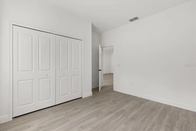a view of an empty room and wooden floor