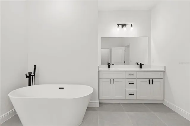 a spacious bathroom with a bathtub sink and mirror
