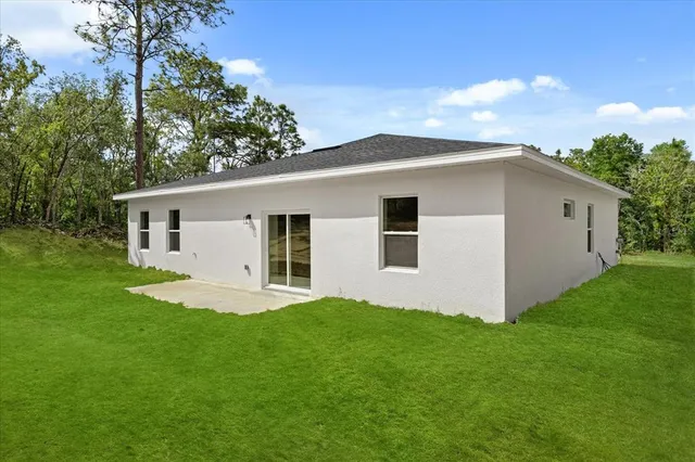 a front view of house with yard and green space