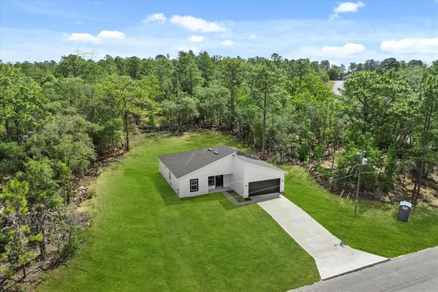 a house with green field in front of it