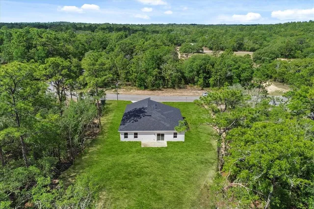 an aerial view of a house with a yard