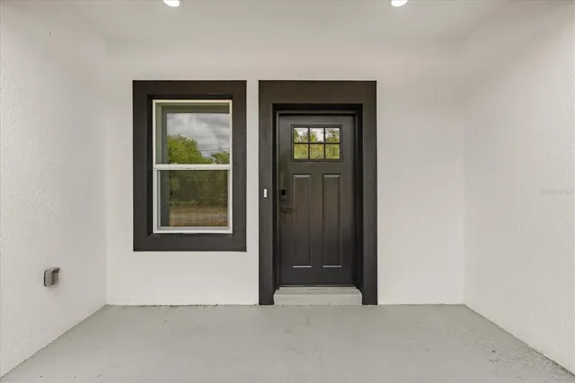 an empty room with windows and closet