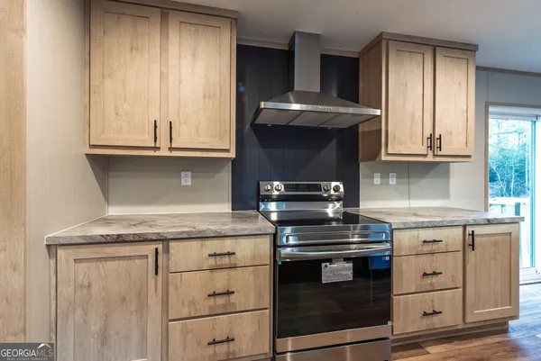 a kitchen with granite countertop a stove and a sink