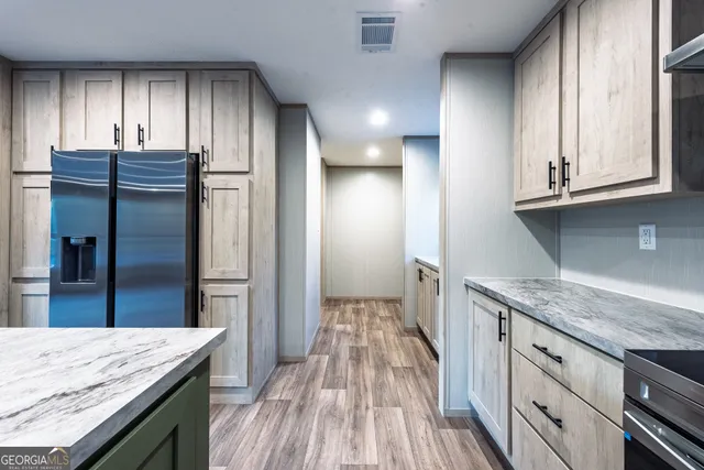 a kitchen with granite countertop wooden cabinets and a granite counter tops