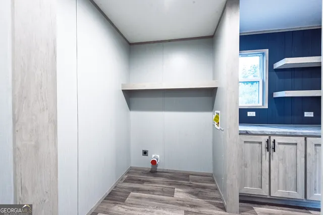 a view of hallway with stairs and wooden floor