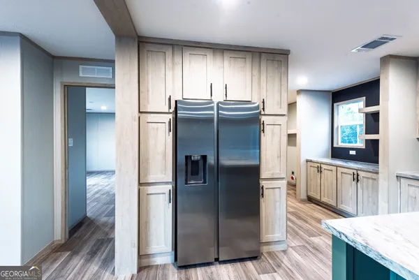 a kitchen with stainless steel appliances granite countertop a refrigerator and a sink