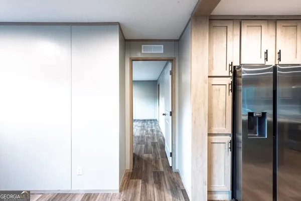 a view of a hallway with wooden floor