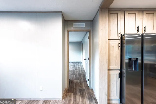 a view of a hallway with wooden floor