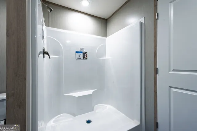 a bathroom with a shower and a toilet