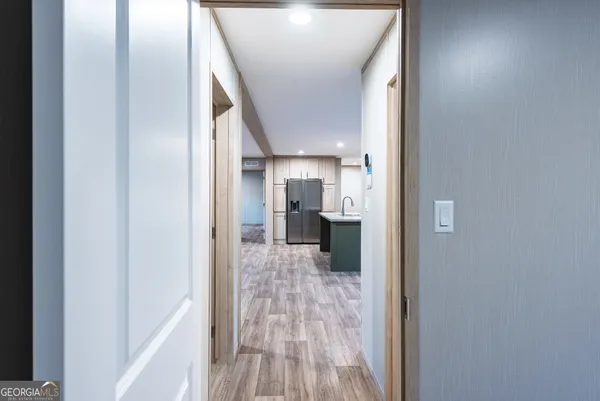 a view of hallway with wooden floor