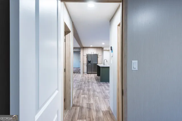 a view of hallway with wooden floor