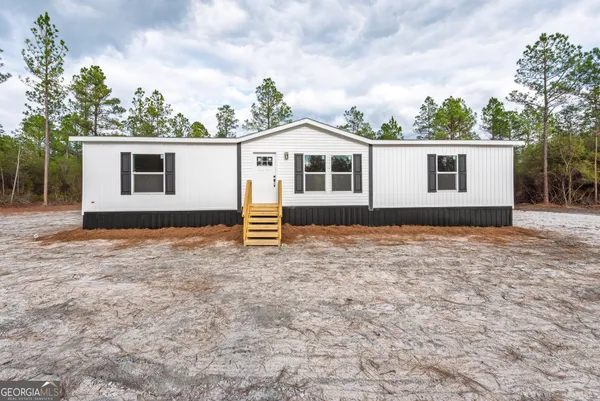 a house with trees in the background