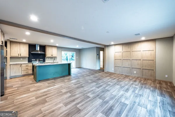 a view of kitchen with kitchen island and stainless steel appliances