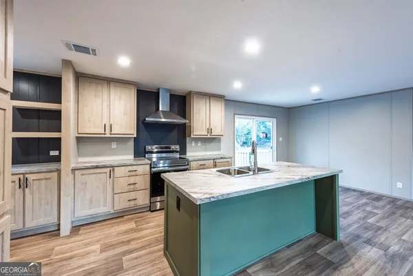 a kitchen with a sink cabinets and wooden floor