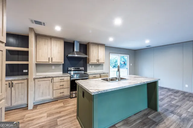 a kitchen with a sink cabinets and wooden floor