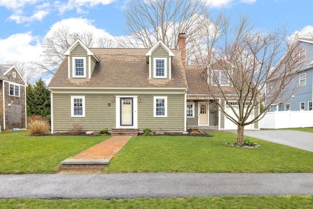 51 Stockdale Road Needham, MA 02492 - Photo 1 of 21 a view of a yard in front of a brick house with many windows