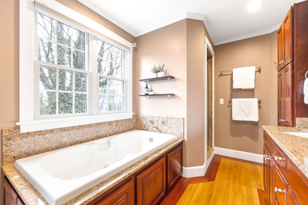 51 Stockdale Road Needham, MA 02492 - Photo 11 of 21 a bathroom with a tub a sink and a large window