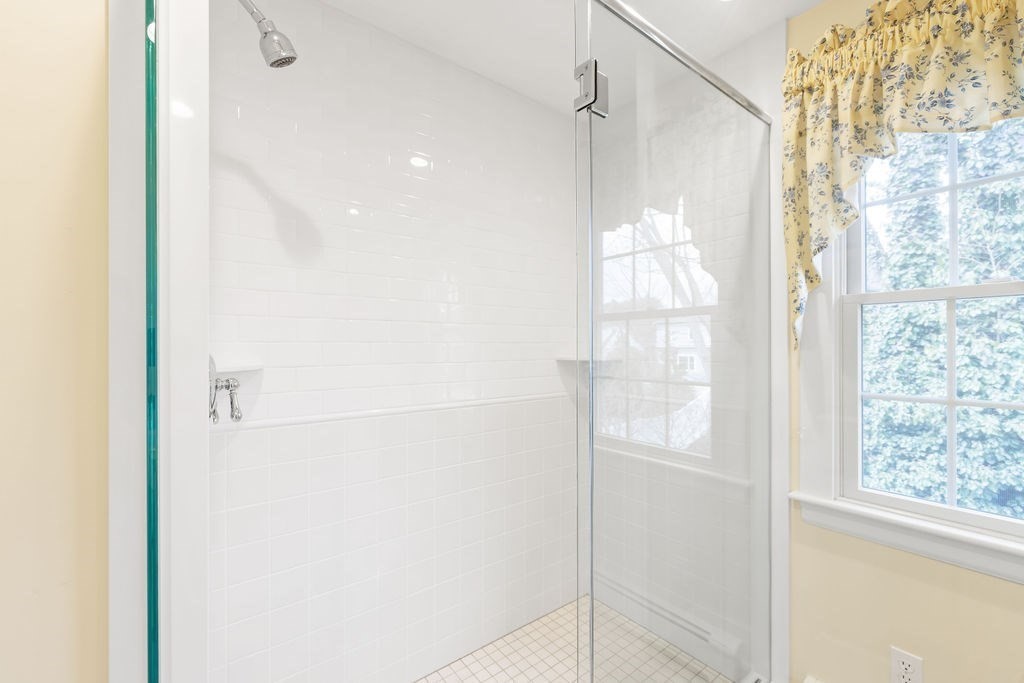 51 Stockdale Road Needham, MA 02492 - Photo 13 of 21 a bathroom with a glass shower door