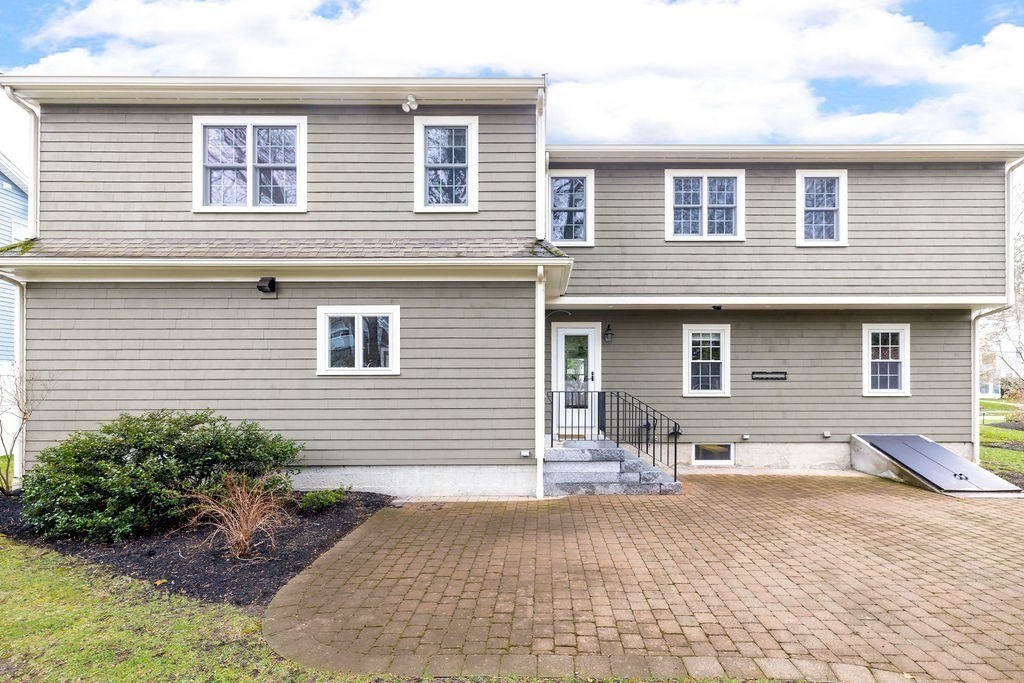 51 Stockdale Road Needham, MA 02492 - Photo 19 of 21 a front view of a house with a yard and outdoor seating