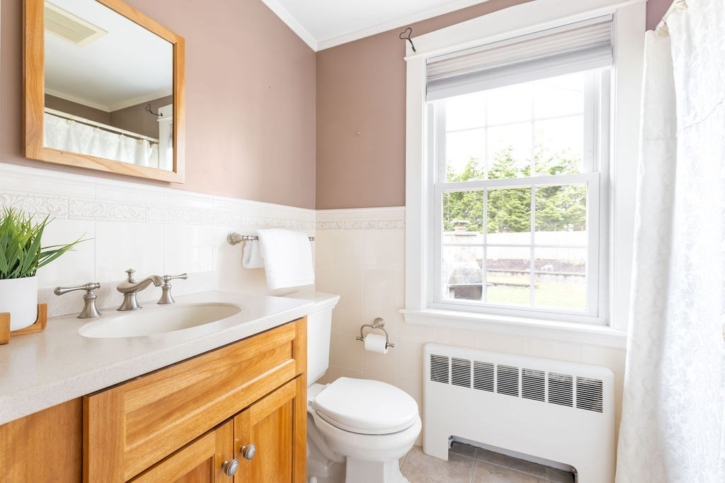 51 Stockdale Road Needham, MA 02492 - Photo 8 of 21 a bathroom with a sink a toilet and a window