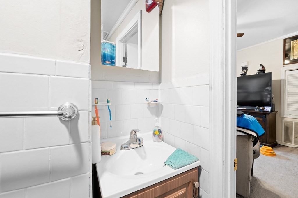 152 Fountain Street Fall River, MA 02721 - Photo 13 of 27 a bathroom with a sink and a mirror