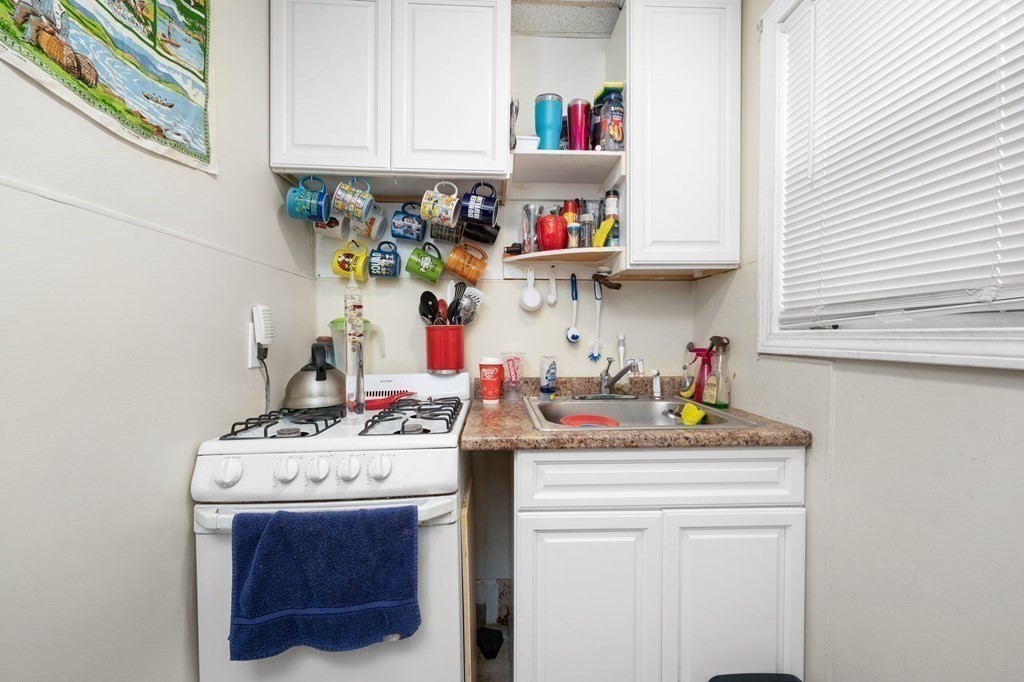 152 Fountain Street Fall River, MA 02721 - Photo 19 of 27 a room with a stove and cabinets