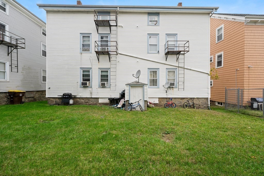 152 Fountain Street Fall River, MA 02721 - Photo 3 of 27 a view of a backyard with plants and a bench