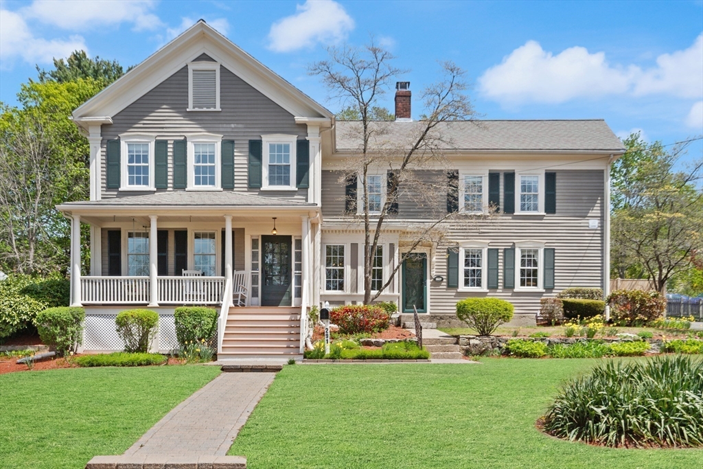 a front view of a house with a garden