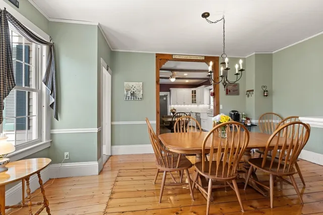 a view of a dining room with furniture and chandelier