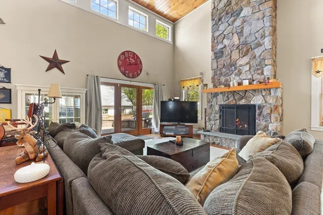 a living room with furniture a fireplace and a flat screen tv