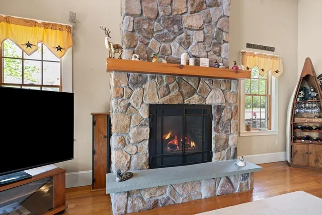a living room with a fireplace and a flat screen tv