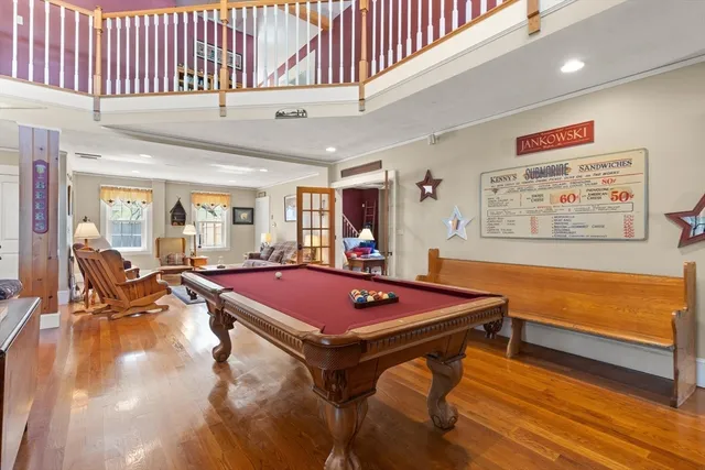 a room with furniture pool table and flat screen tv