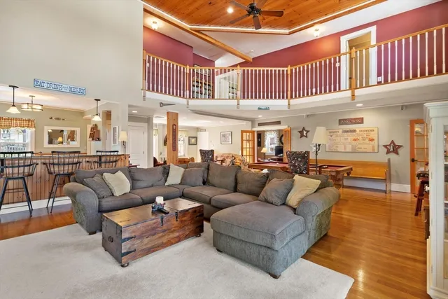 a living room with furniture a ceiling fan and a rug