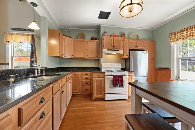 a kitchen with cabinets wooden floor and a sink