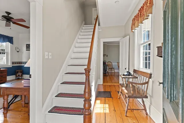 a view of entryway and hall with wooden floor