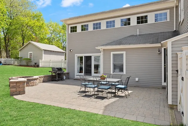 a view of a patio with table and chairs near a yard