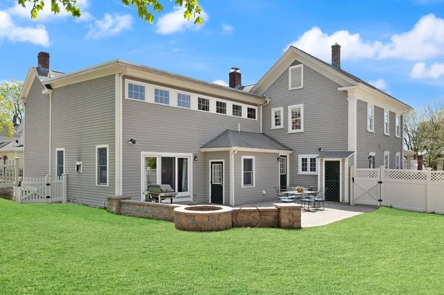 a view of a house with swimming pool and sitting area